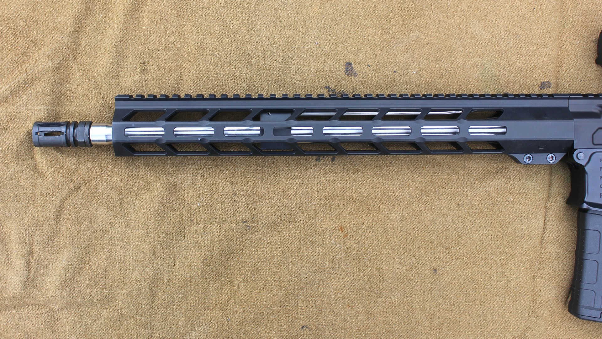 POF-USA LMR Base left-side view of handguard and stainless steel barrel assembly on brown cloth background