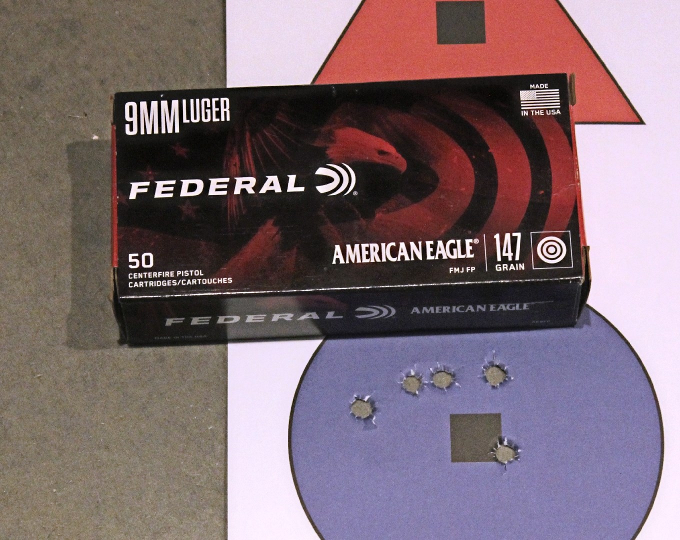 Box of Federal 9mm Luger ammunition next to a five-shot group on a round purple target.