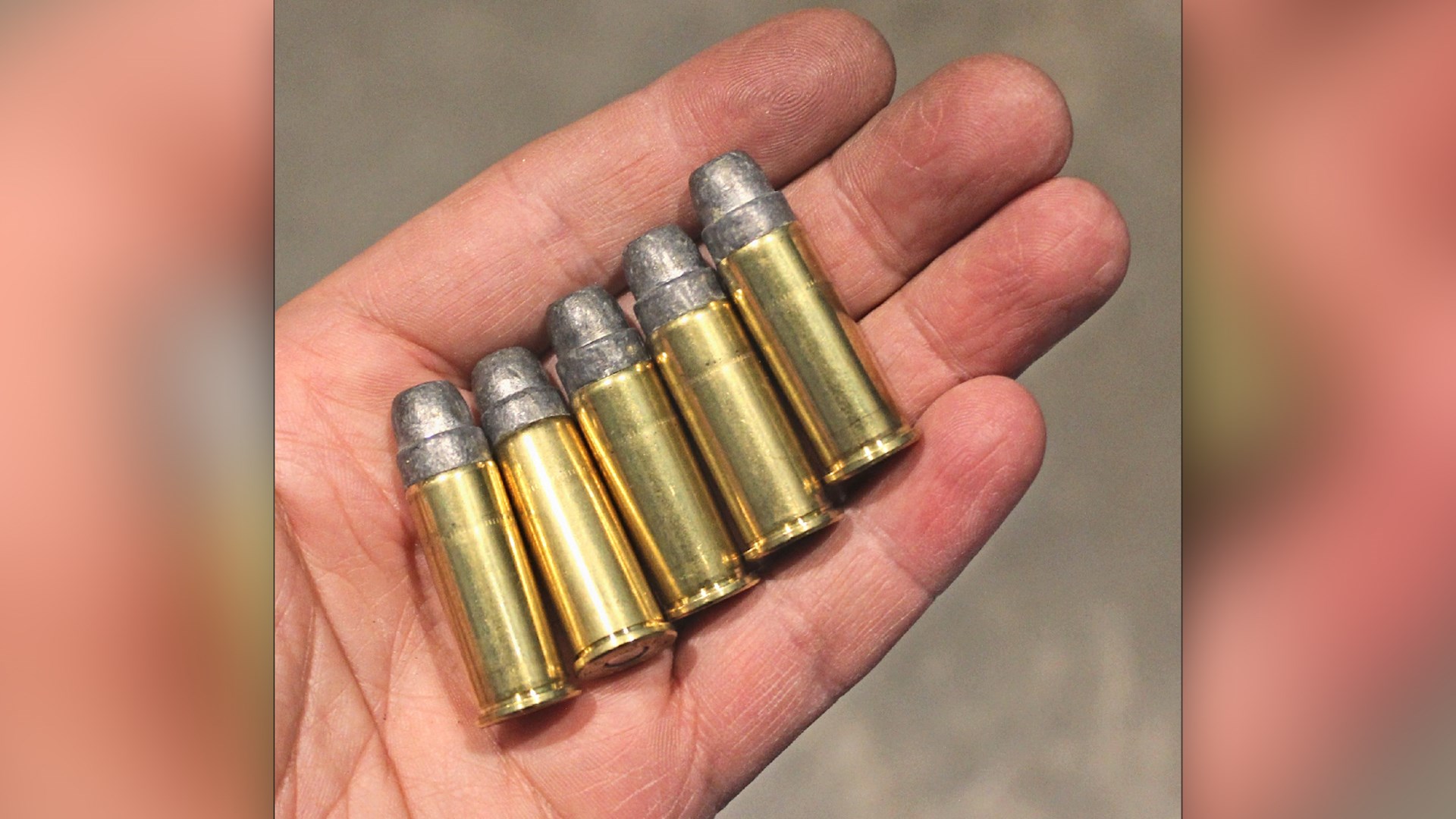 five rounds of ammunition in hand arrangement ammo bullets