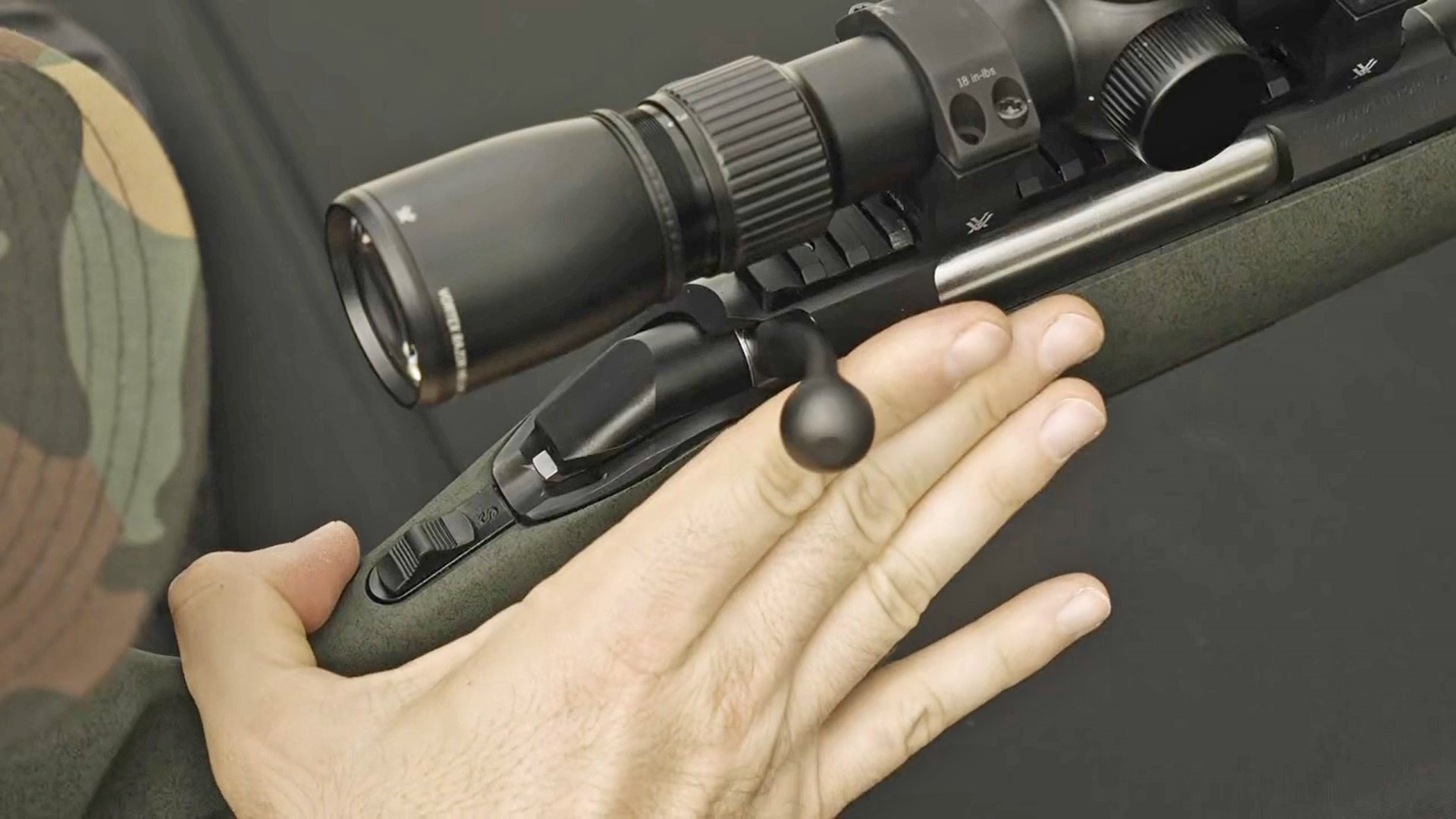 Man operating the bolt handle of a Glenfield Model A bolt-action rifle.