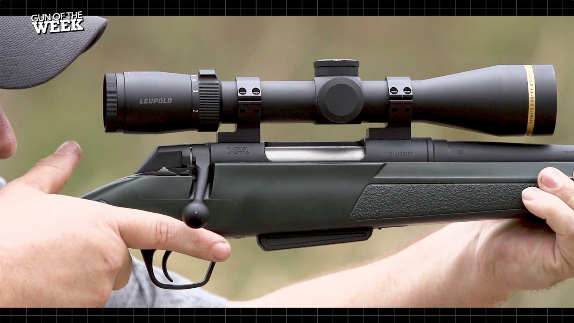 A man aiming the WInchester XPR Stealth SR downrange, with his finger near the trigger.