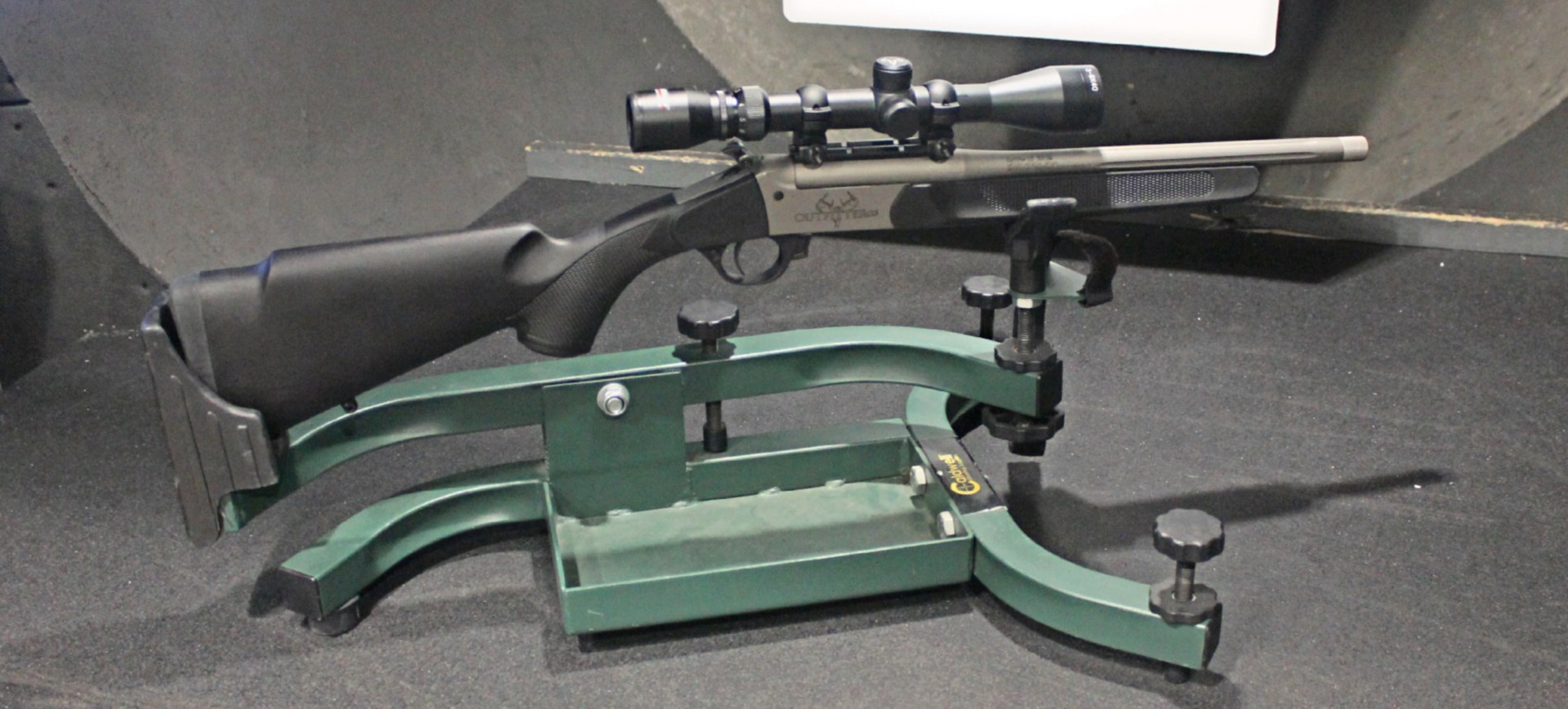Traditions Outfitter G3 rifle in cradle on shooting range right-side view