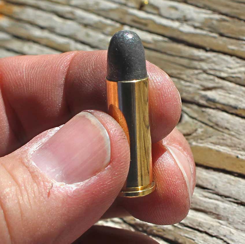 cartridge ammunition brass in hand fingers closeup