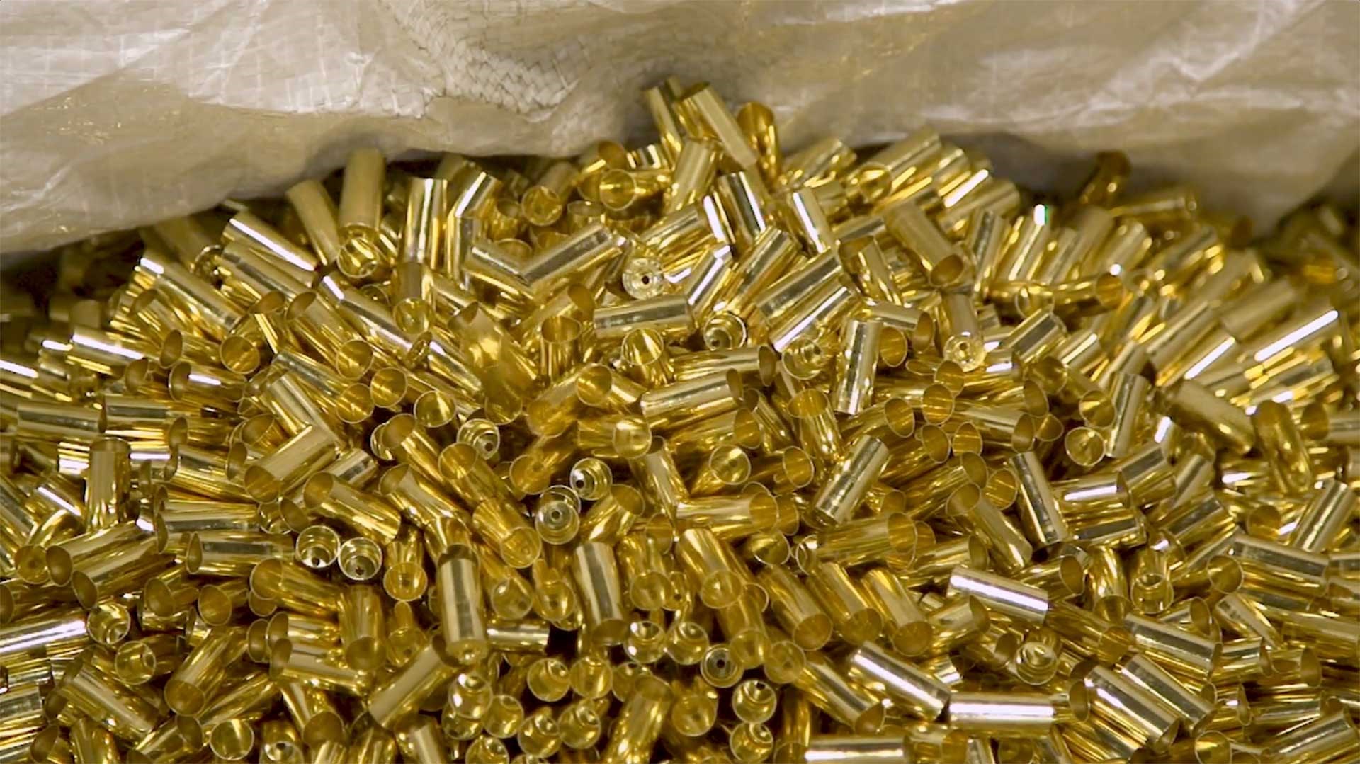 Empty brass cartridge cases in a pile, waiting to be loaded.