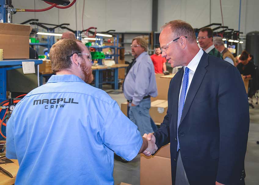 Former Wyo. Governor Matt Mead shakes hands with one of the 200 plus Magpul employees.