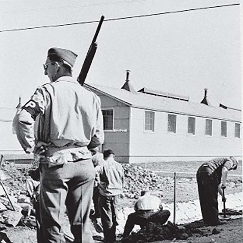 A MP standing guard with a Remington Model 11 in hand.