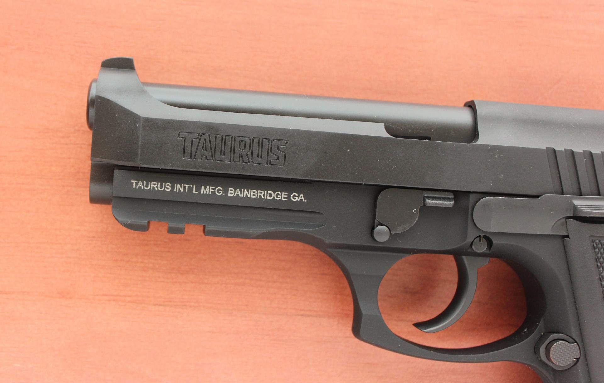 Taurus 917c pistol slide muzzle black gun closeup stamping company name