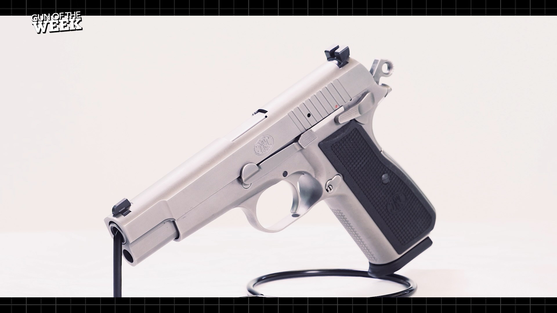 FN America High Power pistol handgun on stand left-side quartering view stainless steel 9 mm gun