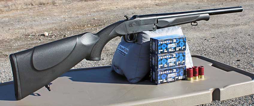 ATI RUKX shotgun single-shot survival gun on table bench with ammunition shooting pose outdoors