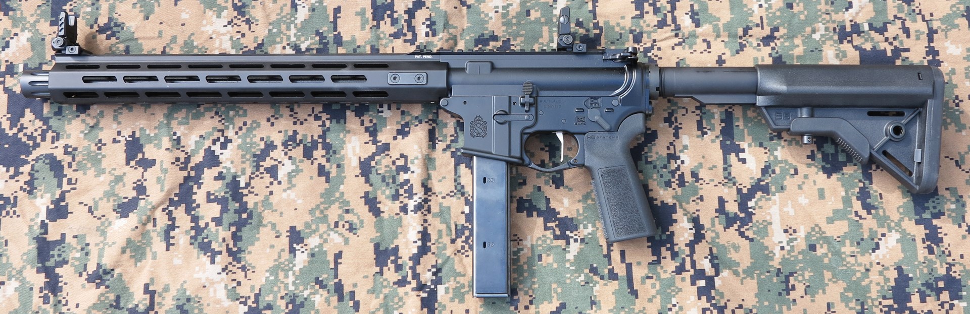 Springfield Armory Saint Victor 9mm Carbine left-side view black ar-15-type semi-automatic rifle 9 mm Luger gun on camouflage material background