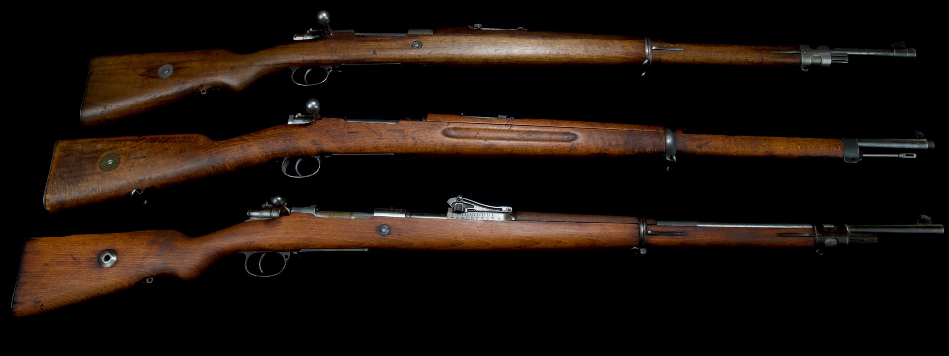 three mauser bolt-action rifles stack row