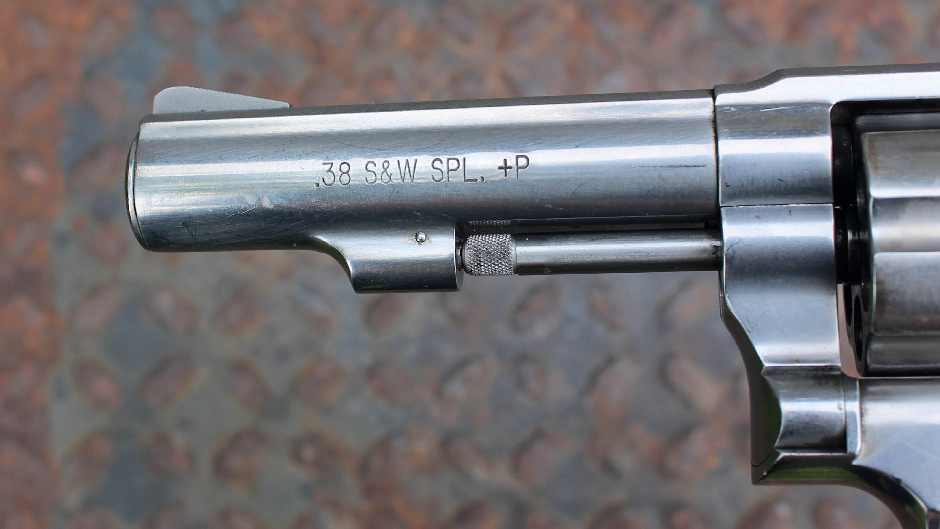 Left-side view of .38 S&W SPL. +P stamp on stainless steel barrel shroud of Smith & Wesson Model 64-8