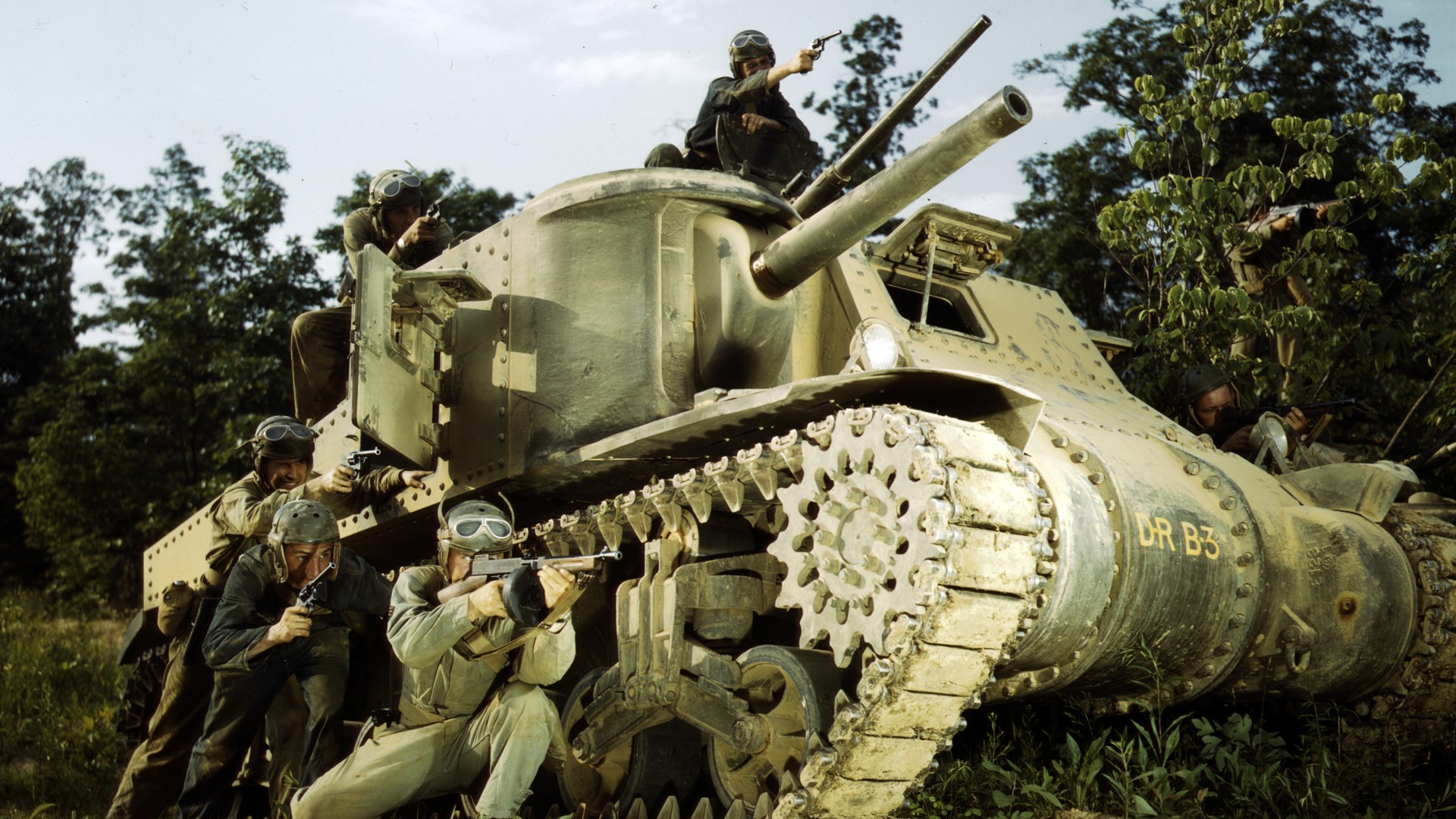 A fanciful pose from training days at Fort Knox: an M3 Lee tank crew with M1917 .45 Cal revolvers and a M1928 Thompson SMG