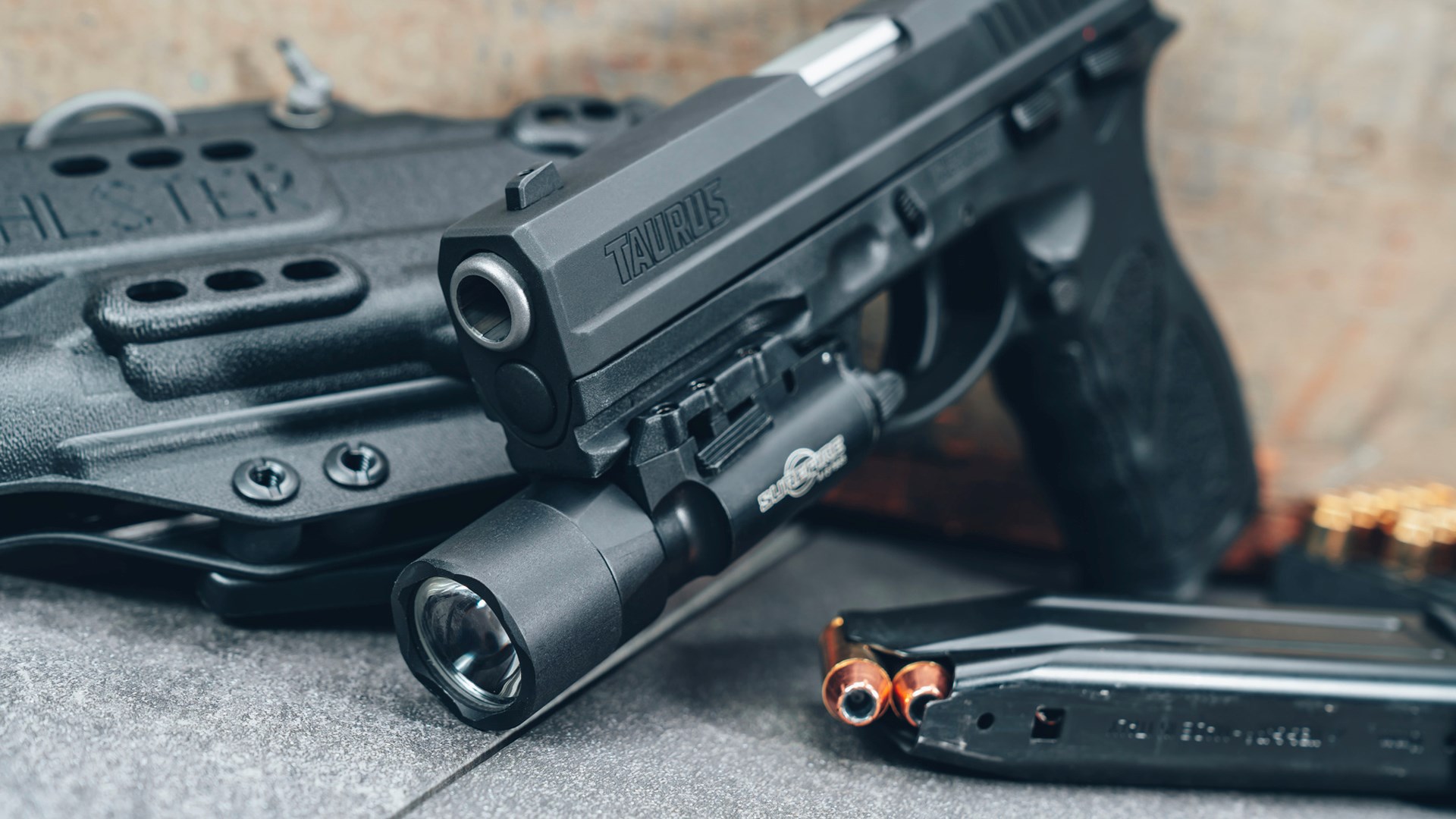 Taurus TH10 shown with a SureFire weaponlight mounted to its accessory rail.