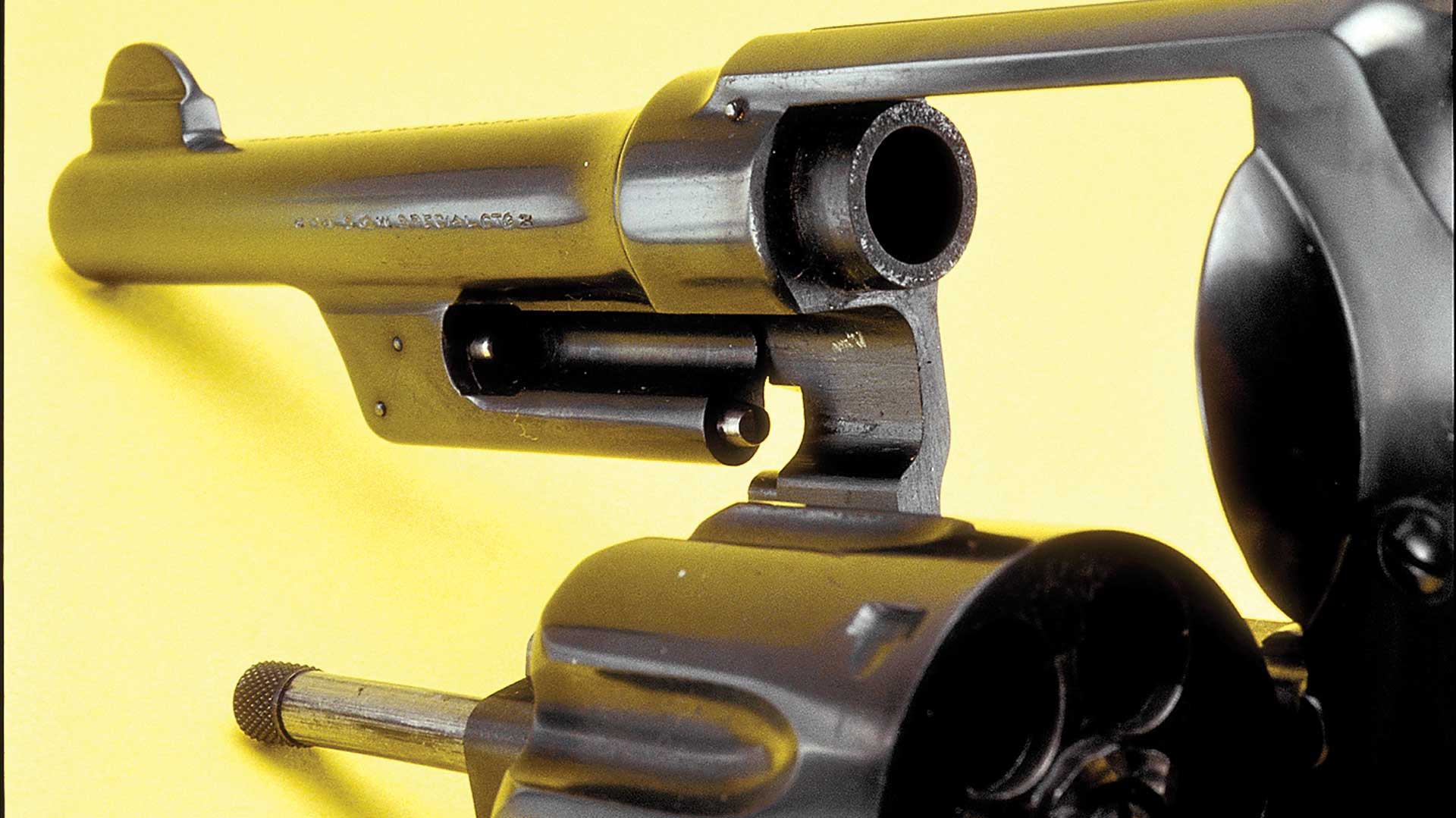 yellow background metal gun revovler cylinder