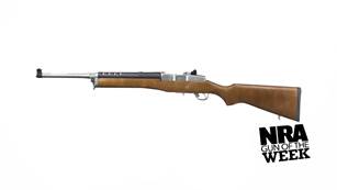 left side semi-automatic rifle carbine Ruger silver barrel wood stock text on image noting: "NRA Gun of the Week"