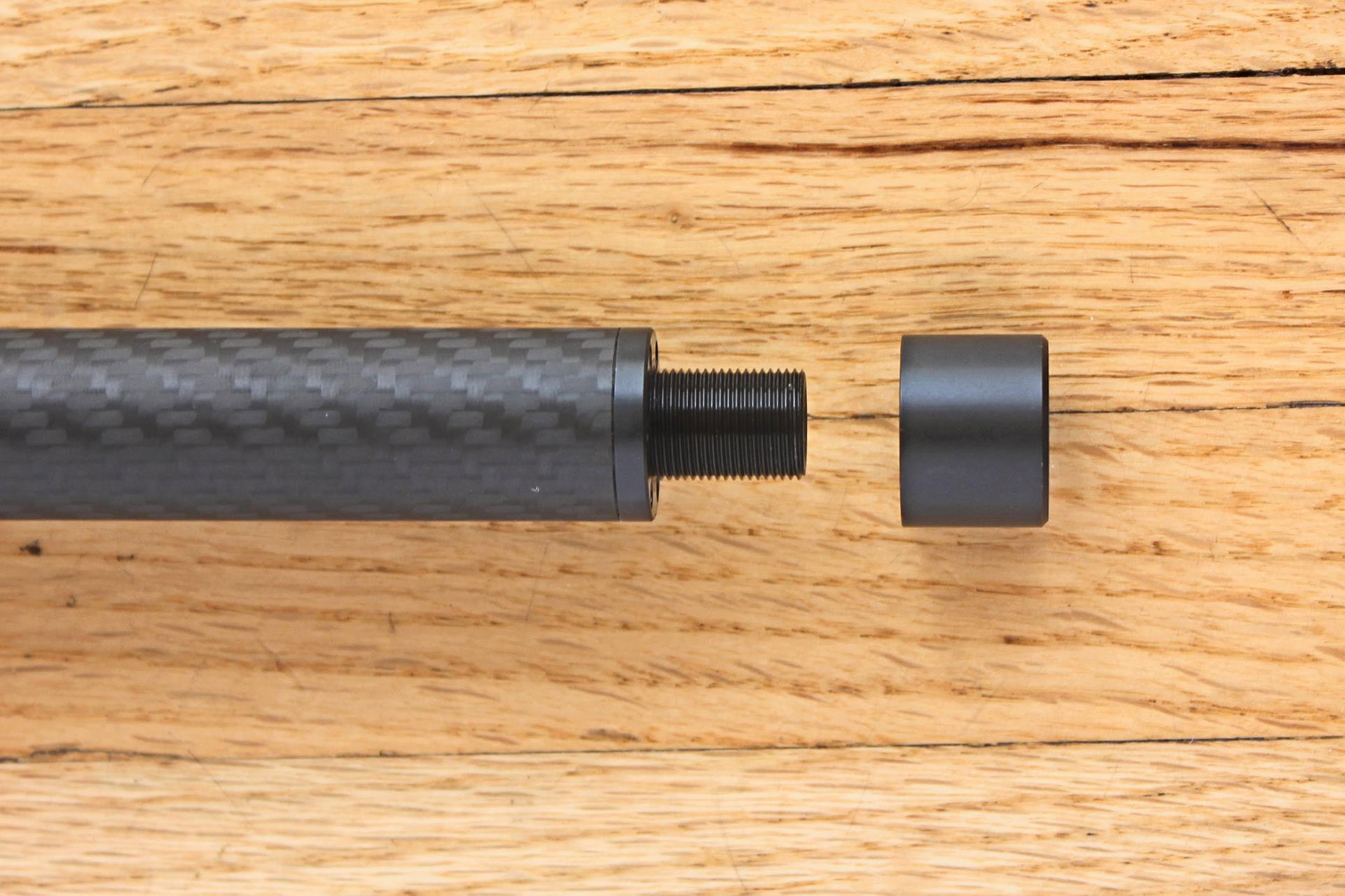 The tensioned carbon-fiber wrapped barrel’s threaded muzzle is fitted with a smooth aluminum thread protector.