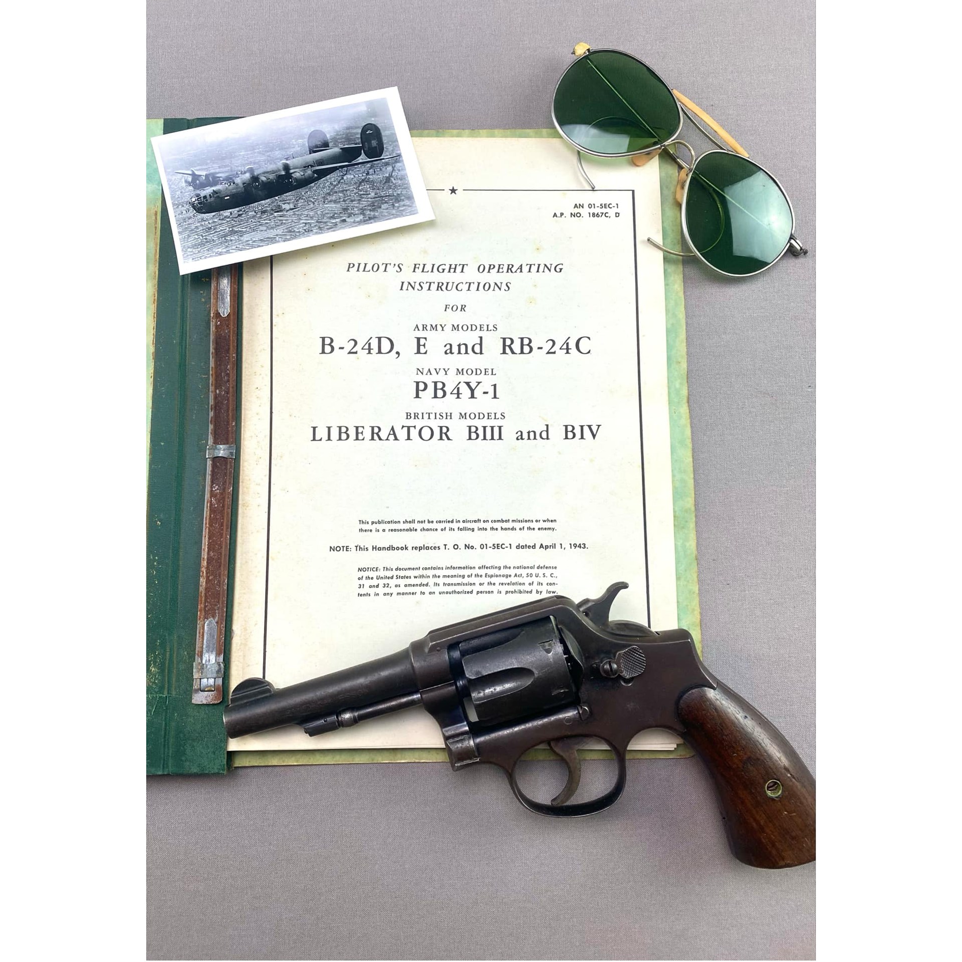 Pilot's Flight Operating Instructions shown with glasses photograph and smith & wesson victory model 10 revolver