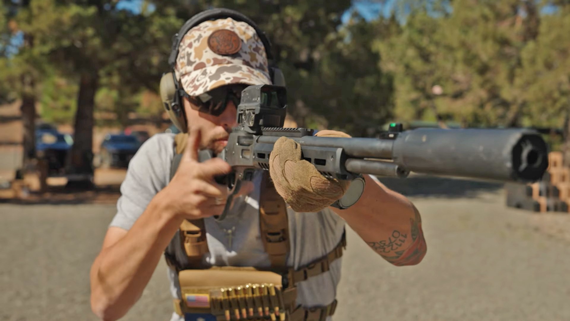 Man aiming a Smith & Wesson Model 1854 Stealth Hunter lever-action rifle equipped with a suppressor.