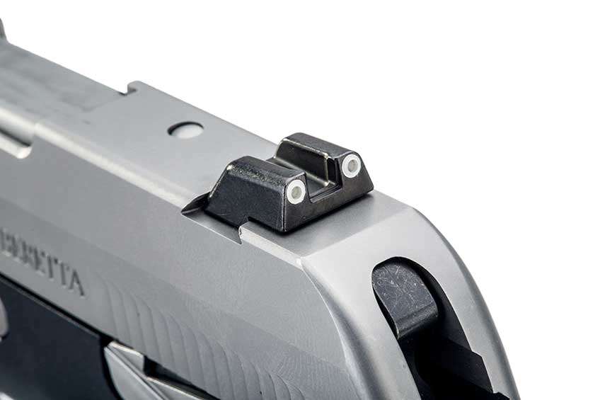 The Beretta Pico rear sight shown on white, displaying two white dots on Trijicon rear sight.