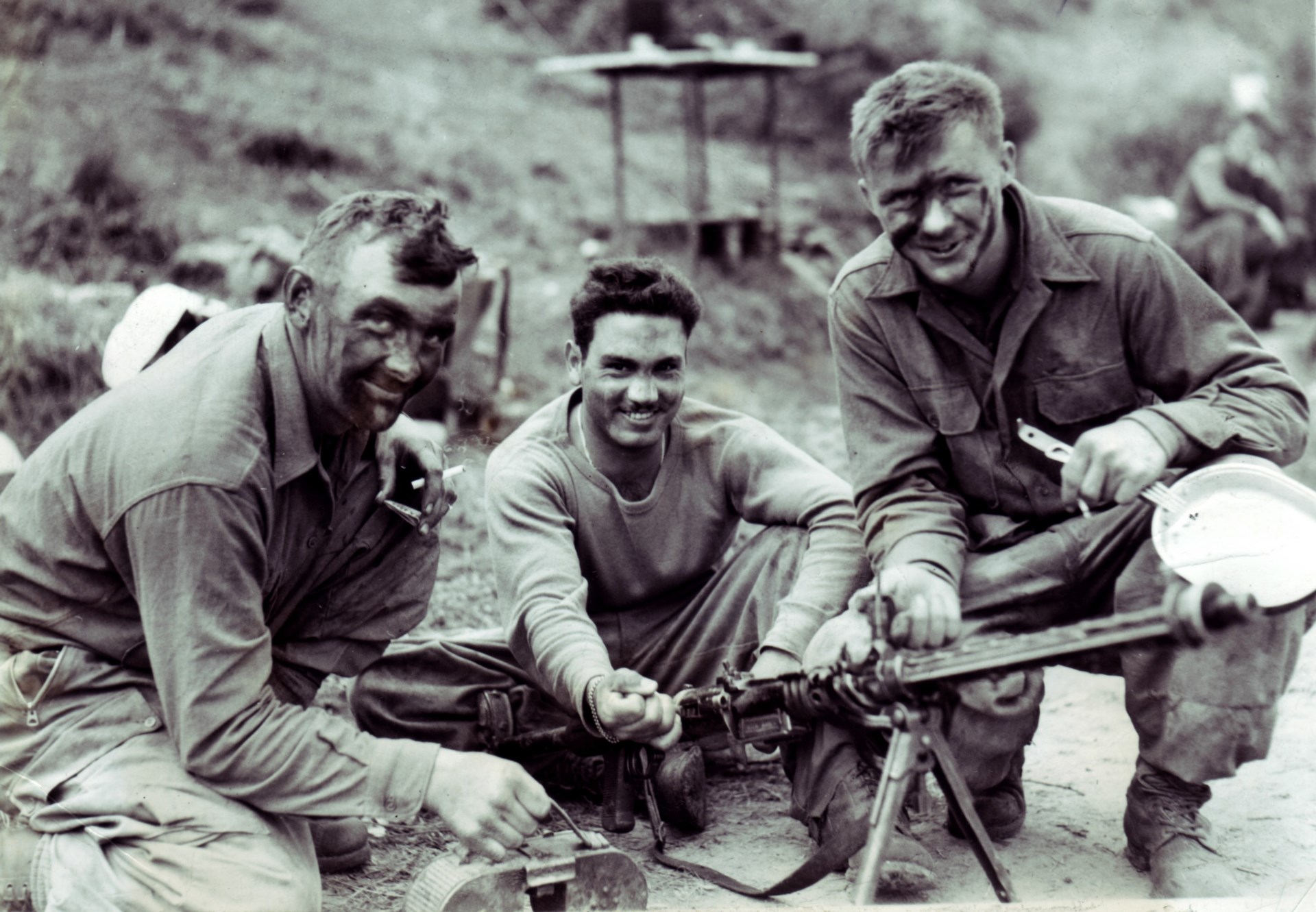 Back from raid: Men of the FSSF examine a captured MG15 light machine gun. Note the 75-round “saddle drum” magazine in the foreground. Anzio area, 1944. NARA