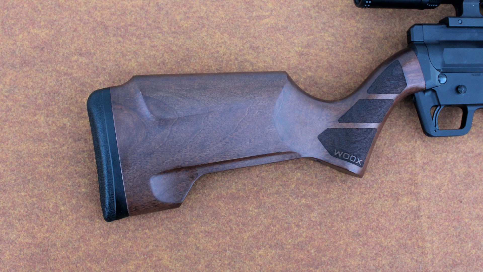 FM Products Rancher Rifle closeup, right-side view of Woox wood buttstock walnut shown with rubber recoil pad, texturing along wrist and undercut relief for supporting bag and raised cheek