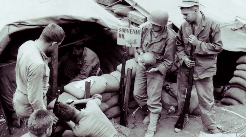 U.S.M.C. “Souvenir HQ” on Iwo Jima soldiers with guns standing around tent sandbags
