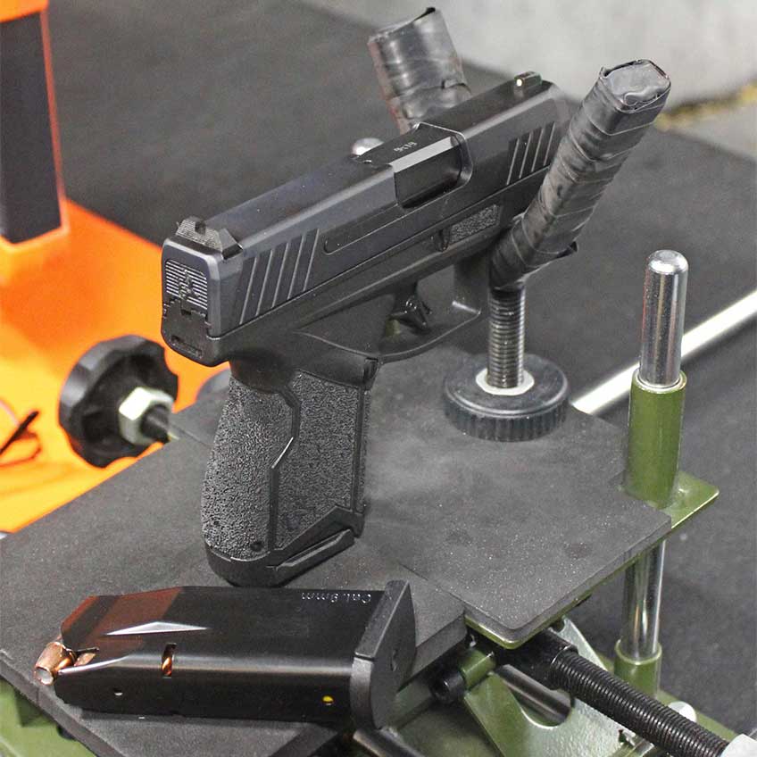 Taurus GX4 pistol in cradle on shooting bench