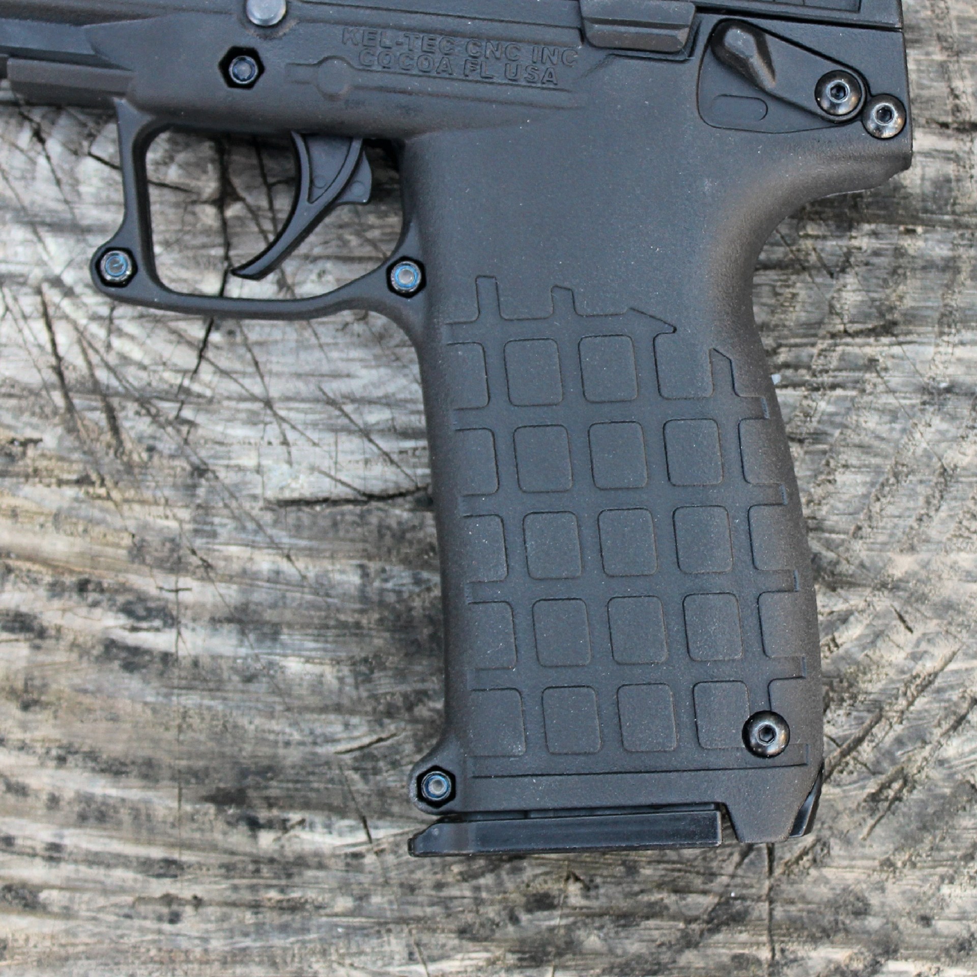 keltech pmr30 black pistol frame .22 WMR gun left-side view cropped closeup shown on wood log