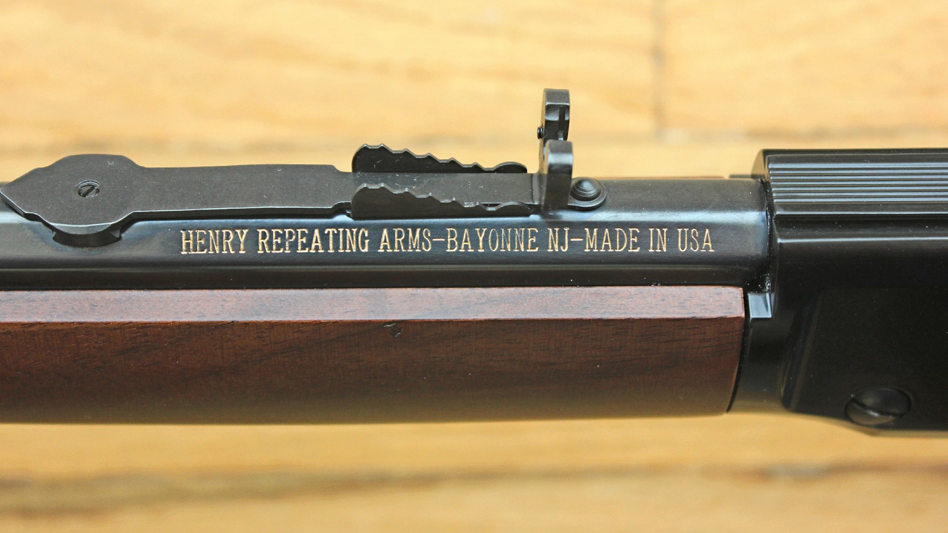 Henry H001 lever-action rifle barrel stamp with gold lettering wood background