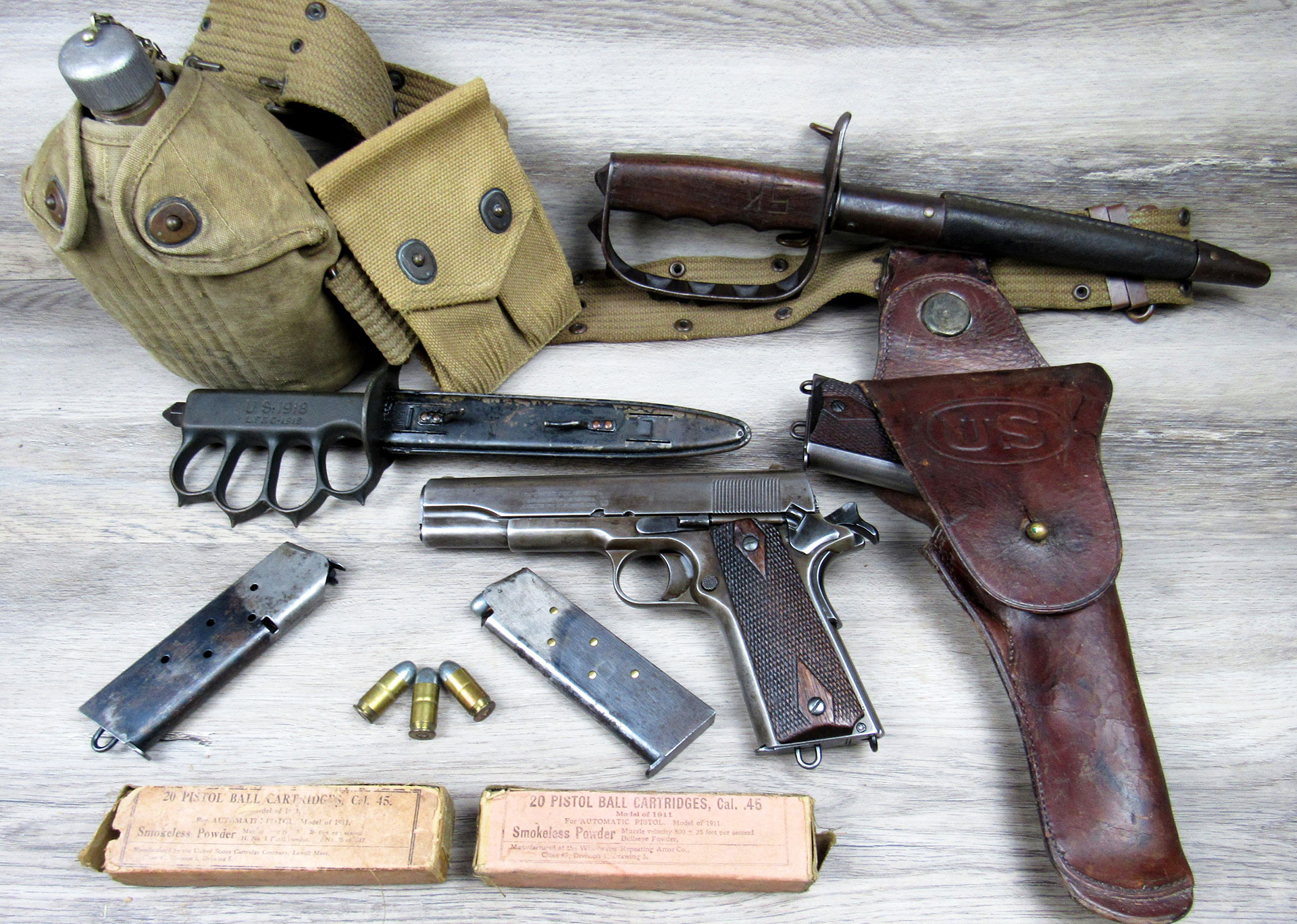 A World War I production M1911 pistol, with associated AEF gear and equipment from the period. Photo credit Mike Gruber Collection.