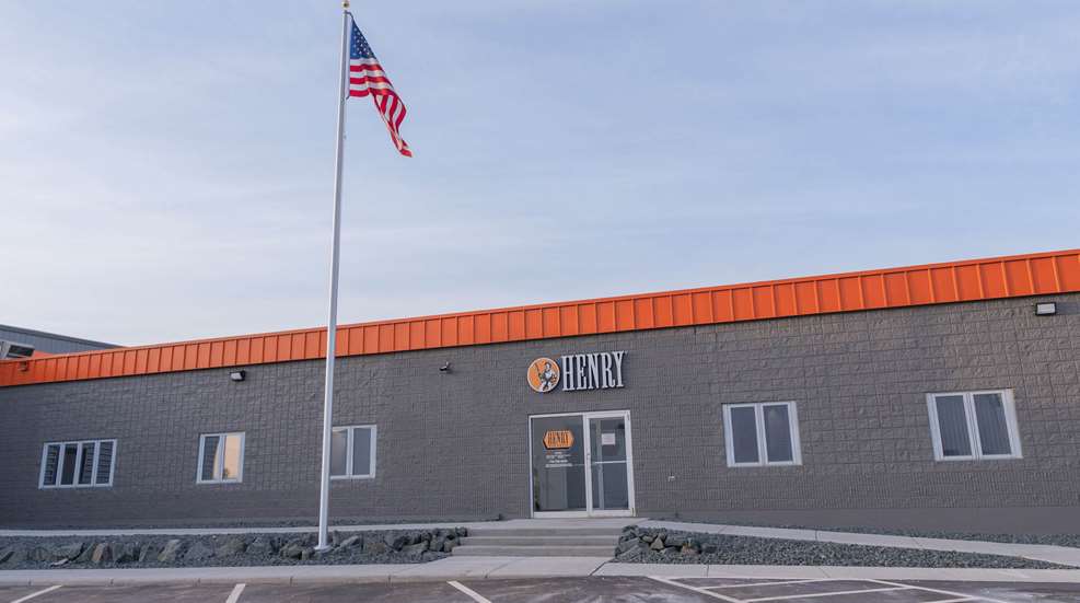 Henry Repeating Arms headquarter building brick windows flag cloudy sky above
