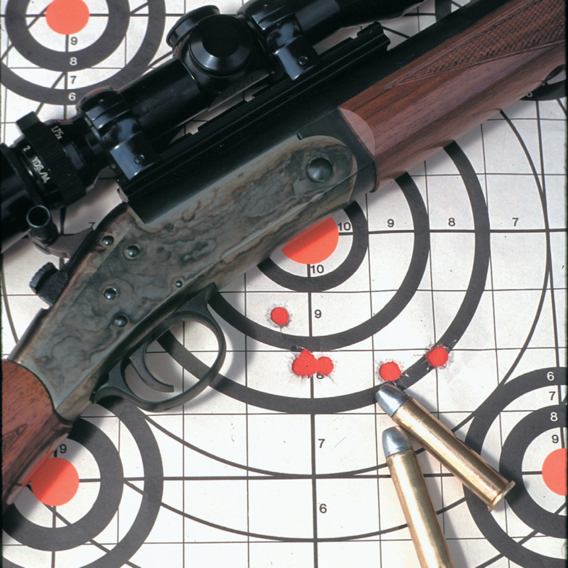 rifle on target with groups and ammo