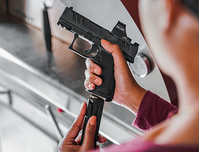 F-Series gun controls in hand pistol ammo loading overshoulder angle shot