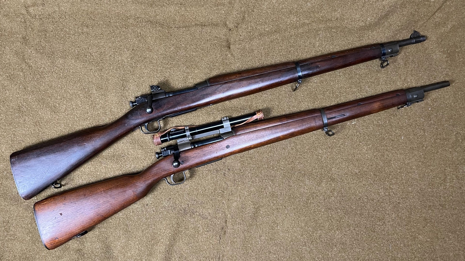 Comparison between two wood-stocked M1903 military surplus rifles on wool blanket