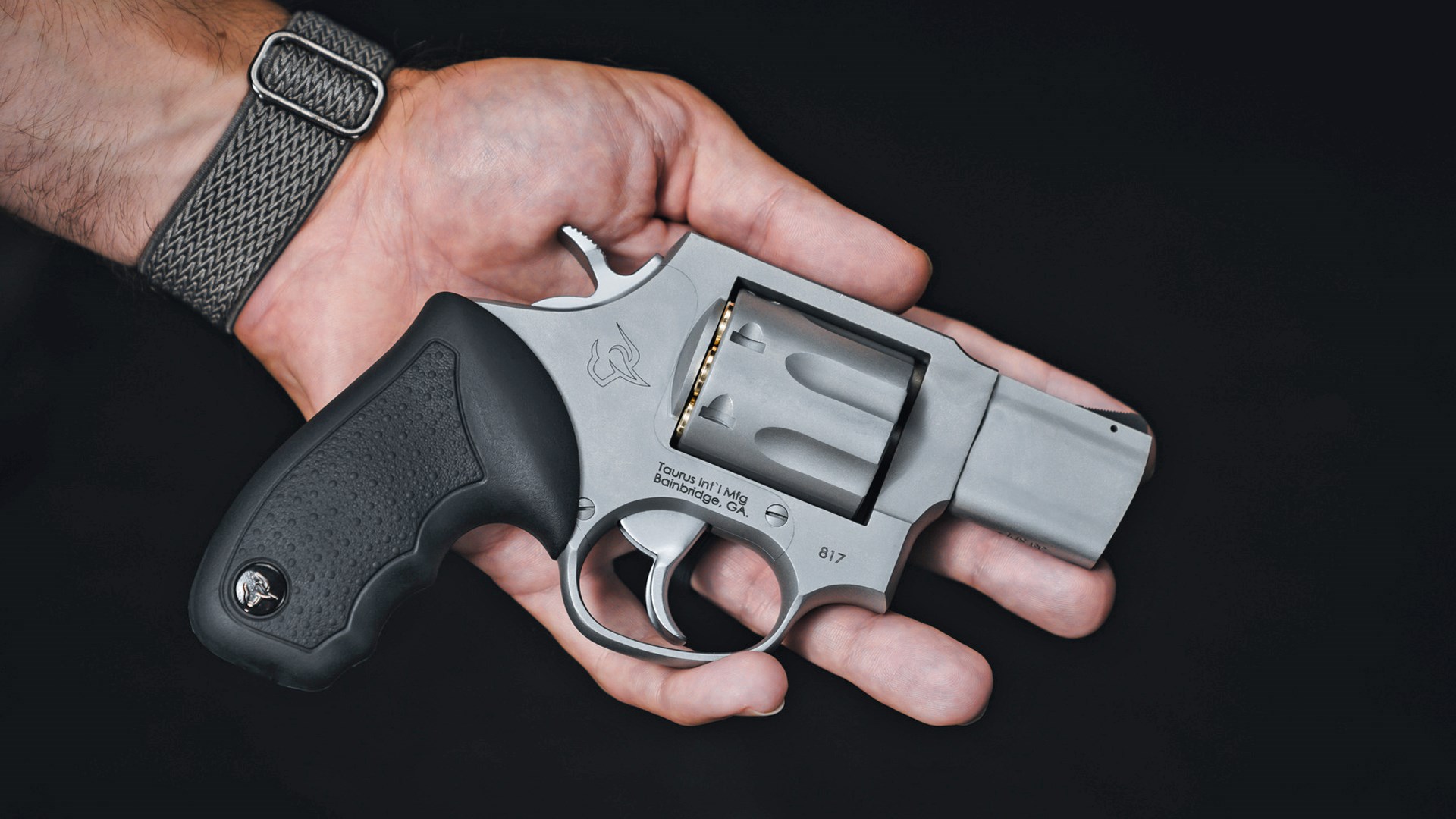 Man holding the Taurus 817 revolver in an open hand.