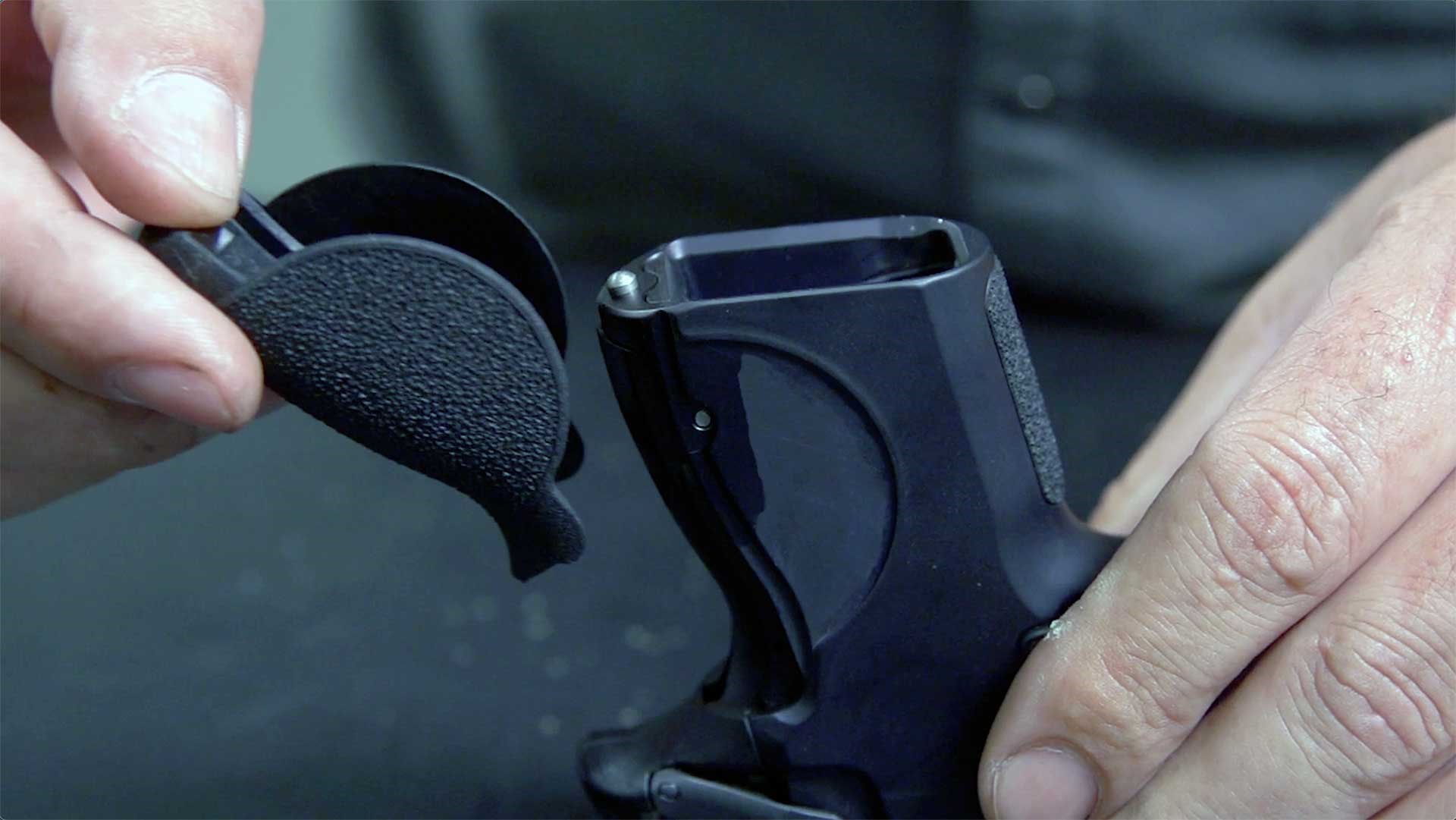 A user removing the interchangeable backstrap panel on the Smith & Wesson CSX.