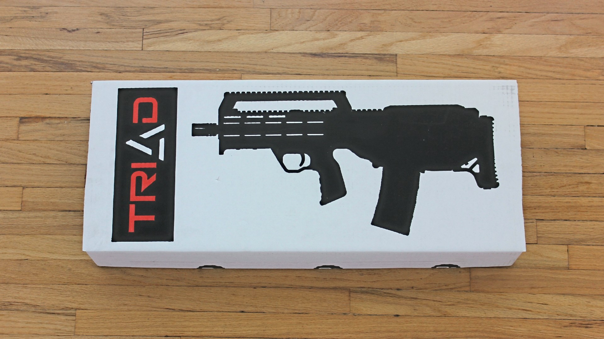 Left-side view of A3 Industries Triad bullpup conversion box on wood floor
