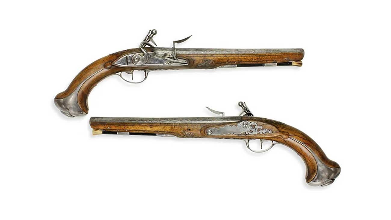 The Washington/Lafayette pistols shown on white