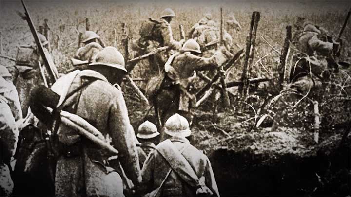 French soldiers advancing through barbed wire during World War I.