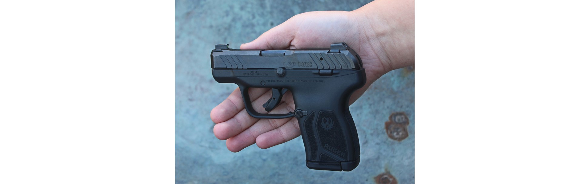 Ruger LCP MAX pistol in hand black gun smallest