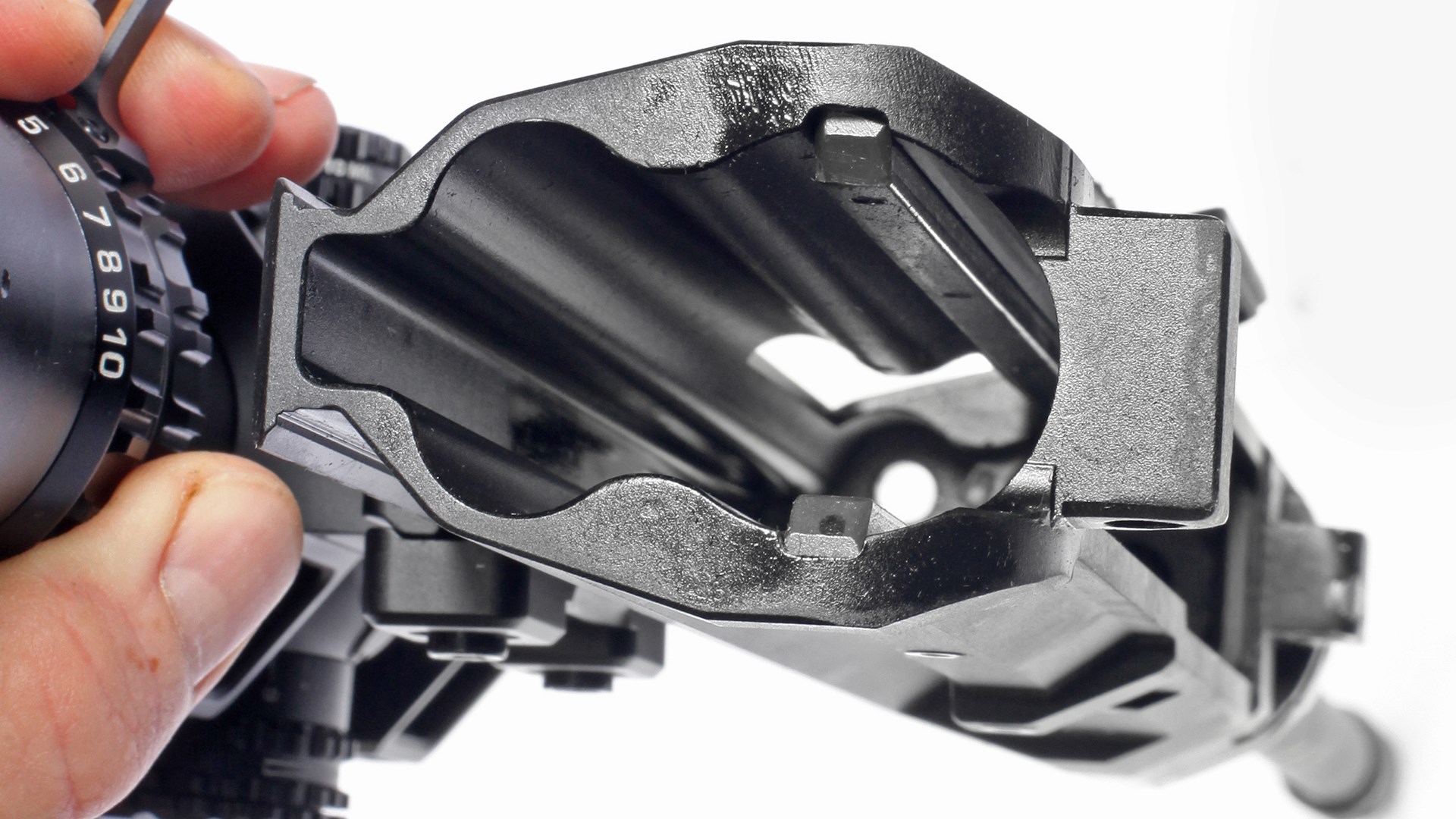 Zenith ZF-56 receiver inside view with riflescope ocular zoom ring visible numbers hand white background