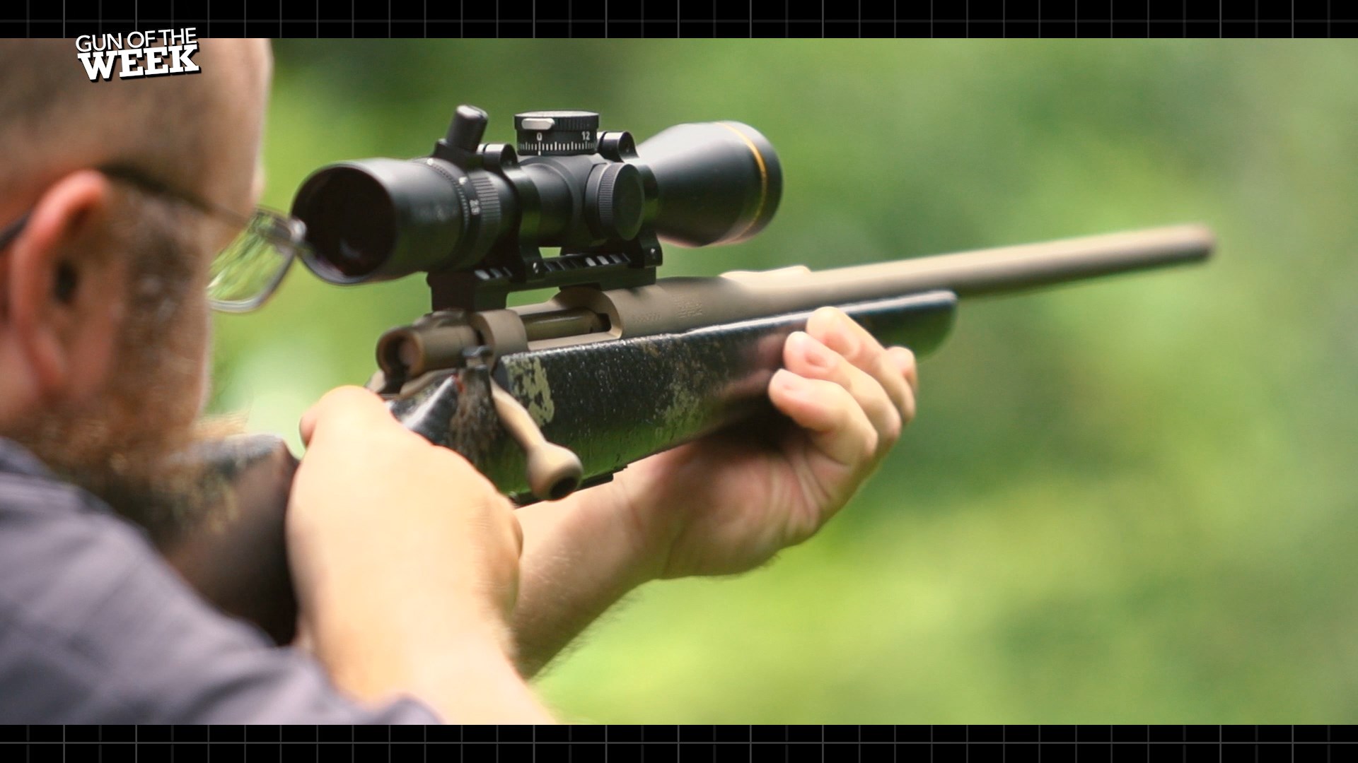 rear view of man shooting holding bolt-action Howa M1500 Super Lite Carbon bolt-action rifle target shooting hunting
