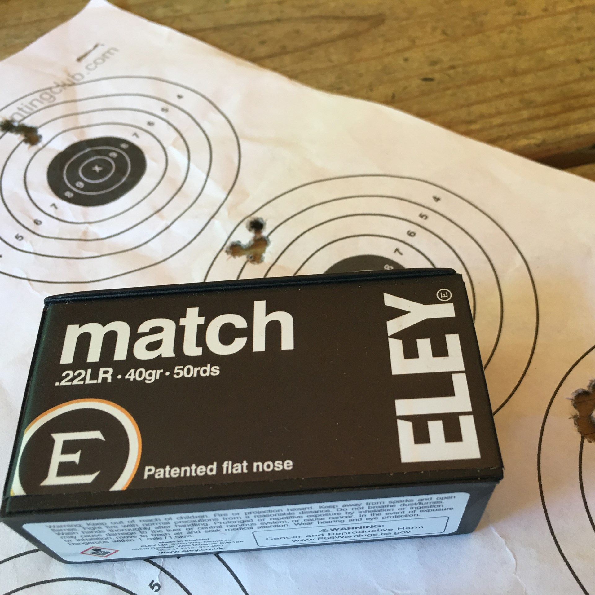 Eley Match .22LR ammunition box shown with white bullseye target and accuracy holes groups