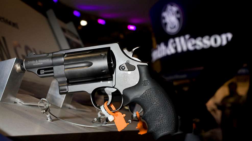 left-side view smith & wesson black revolver rack display show dark ominous