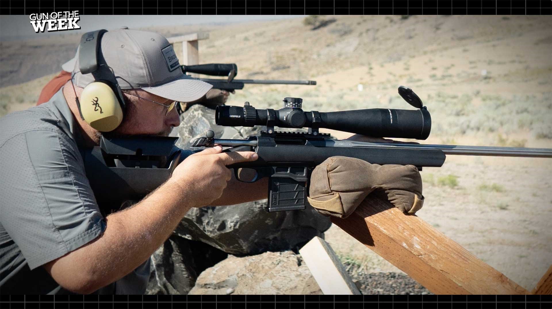 A man shooting the Browning X-Bolt Target Max off an improvised bag rest.