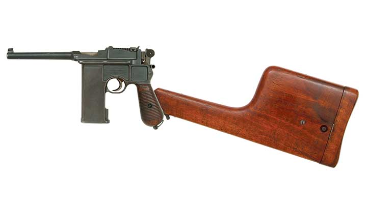 A Mauser C96 shown on white with its attached shoulder stock that doubles as a holster.