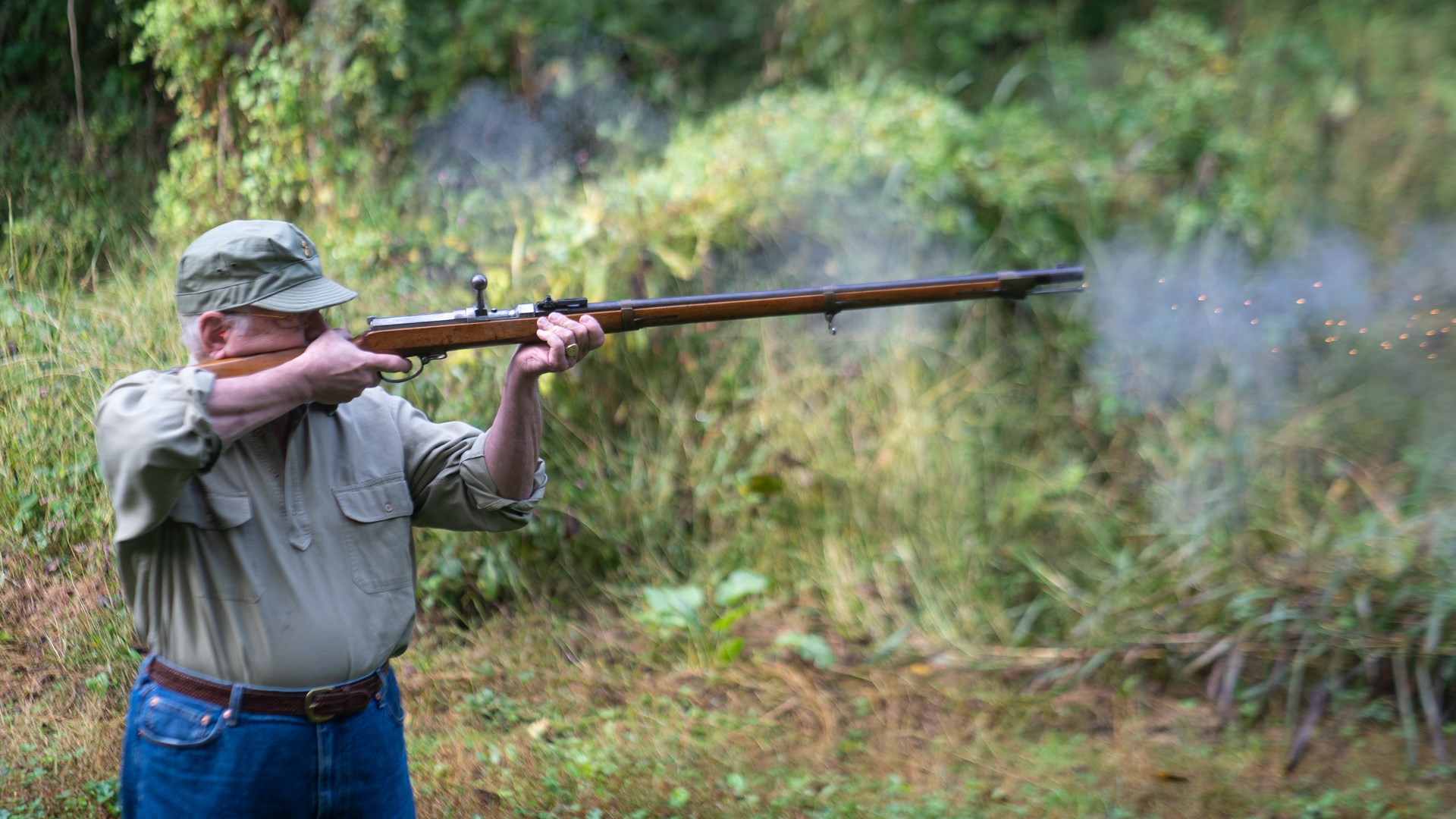 man standing outdoors holding and firing a dreyse needlegun chassepot smoke sparks recoil