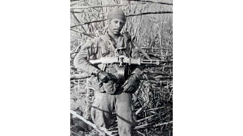 Vietnam-era SOG warrior shown in thick jungle with a cut-down RPD machine gun.
