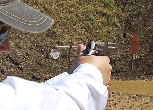 man outdoors handgun shooting pistol